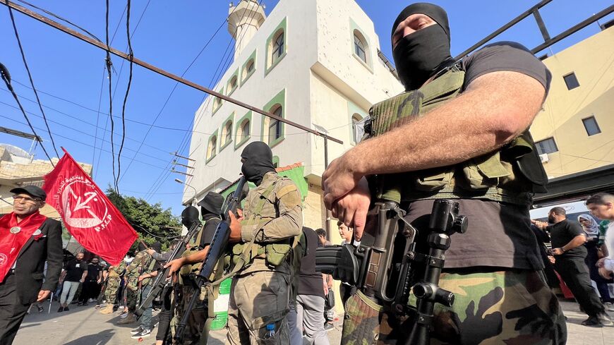 Armed and masked men attend the funeral of two militants from the Popular Front for the Liberation of Palestine in Ain el-Hilweh refugee camp near Sidon on Nov. 1, 2024.
